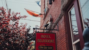 A hotel sign with the name "Hotel Belvidere" and a phone number.