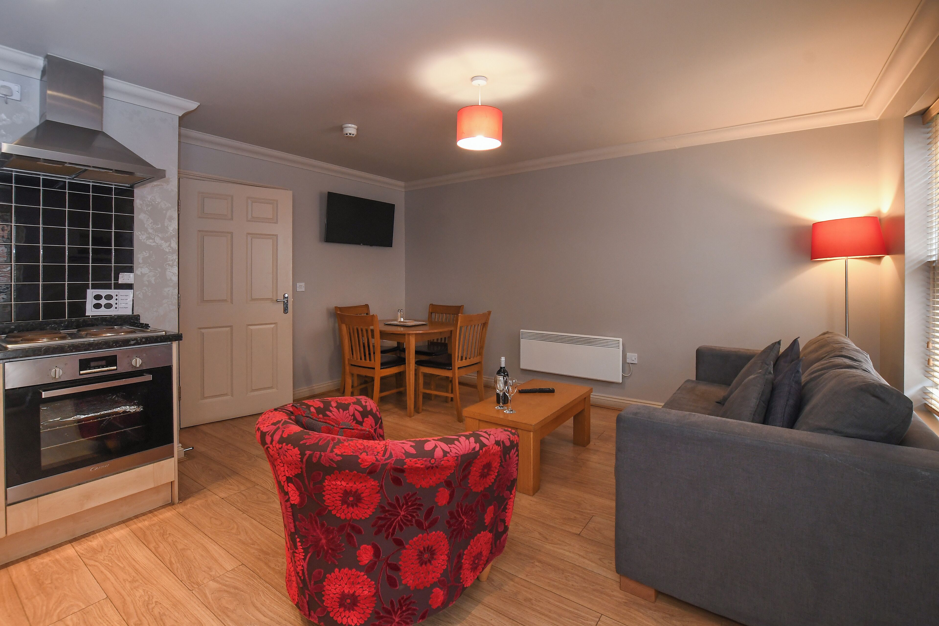 A compact living space with a kitchenette, a dining area, and a seating area.