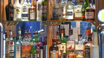 A bar with various liquor bottles and a selection of glasses.