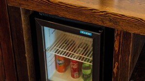 A minibar with bottled water, a coffee maker, and a small refrigerator containing beverages. - Manaspark Deluxe Hotel (Fethiye)