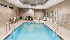 A swimming pool with a marble wall and a 'No Diving' sign, surrounded by chairs and a reception area. - Microtel by Wyndham Penn Yan Finger Lakes Region (Penn Yan)