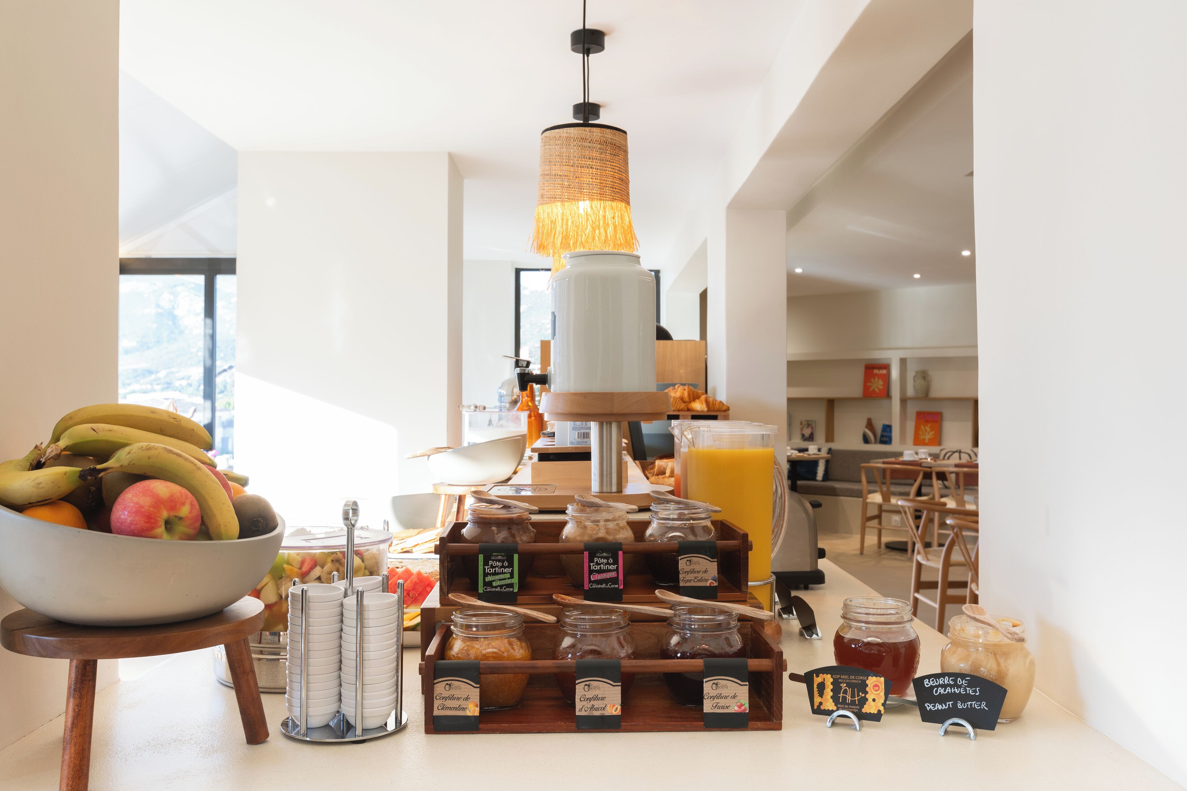 A breakfast buffet with a variety of fruits, cereals, and spreads.