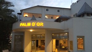 A hotel entrance with a sign reading "PALM D'OR" and a modern architectural design. - Palm Dor Hotel (Manavgat)