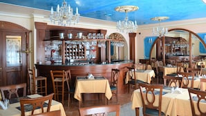 A restaurant with wooden furniture, chandeliers, and a bar area. - Renesance Krasna Kralovna (Karlovy Vary)
