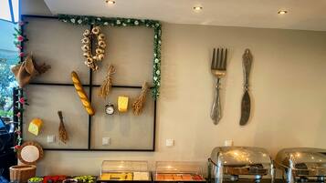 A buffet setup with various food items and utensils.