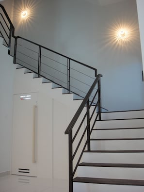 A staircase with black railings and white steps.