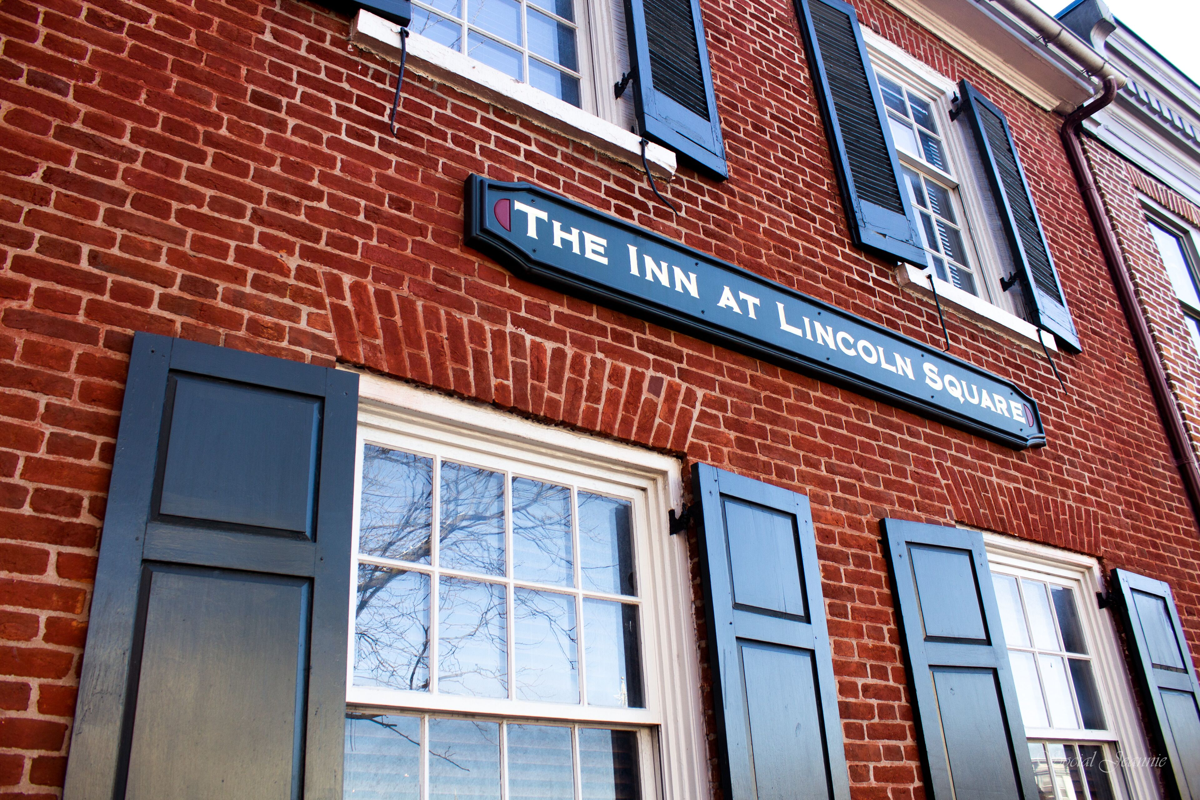 A brick building with a sign reading "The Inn at Lincoln Square."