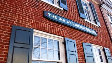 A brick building with a sign reading "The Inn at Lincoln Square."