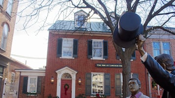 Welcome to The Inn at Lincoln Sq, a charming brick building with a welcoming entrance.