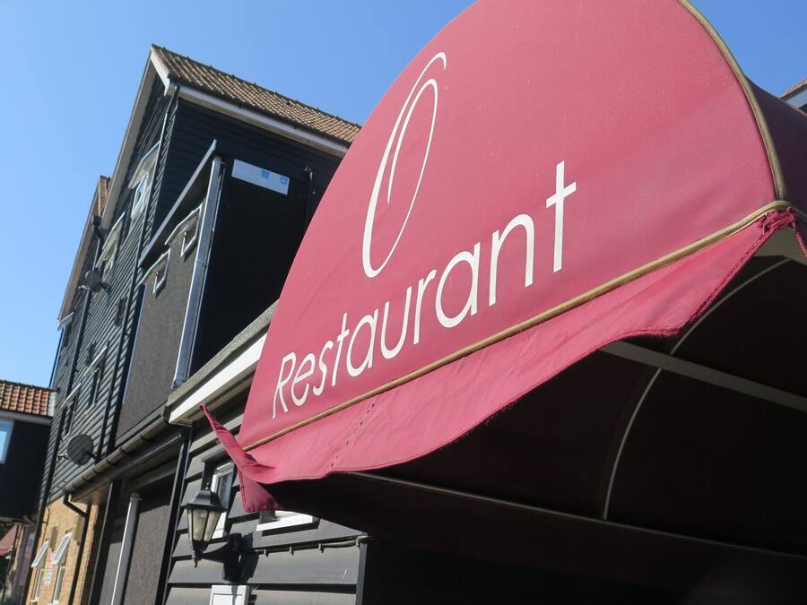 A red awning with the word "Restaurant" in white letters.