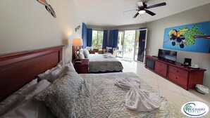 Una habitación de hotel con dos camas, televisión, cafetera y un cuadro.