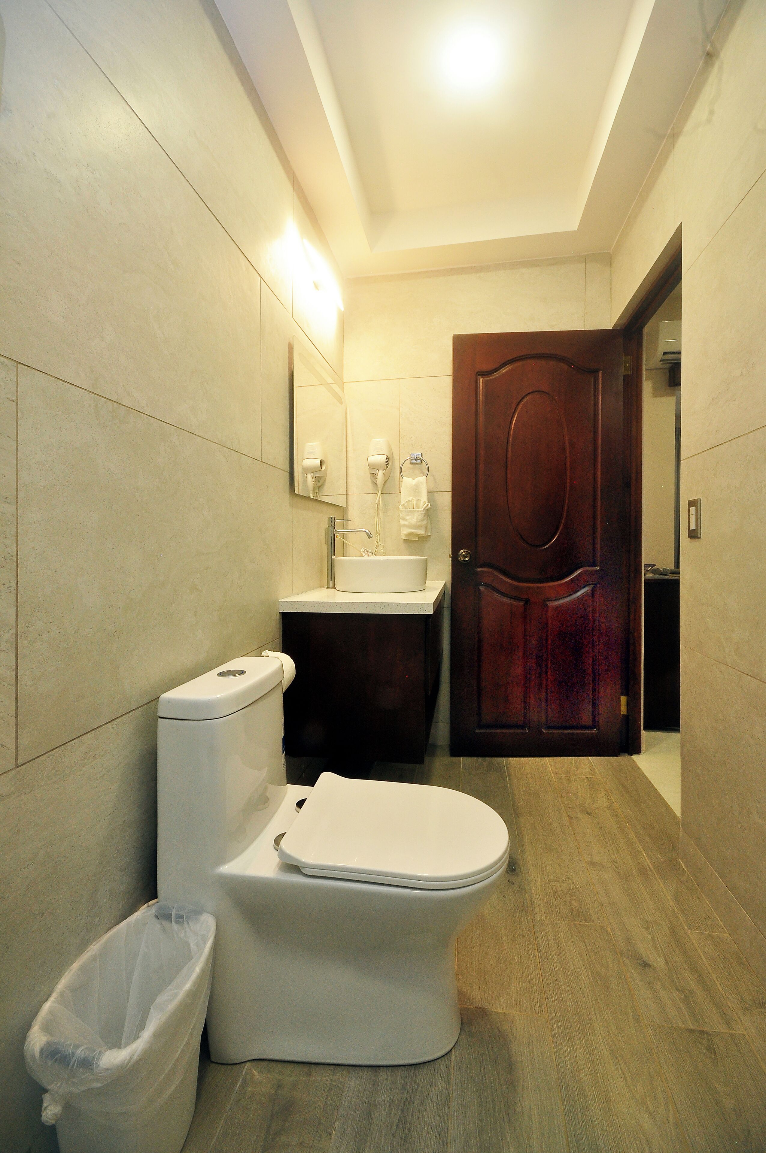 A modern bathroom with a toilet, sink, and vanity.