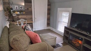 Business Apartment | Living area | 32-inch flat-screen TV with cable channels, TV, fireplace - Hitching Horse Inn (Pierre)