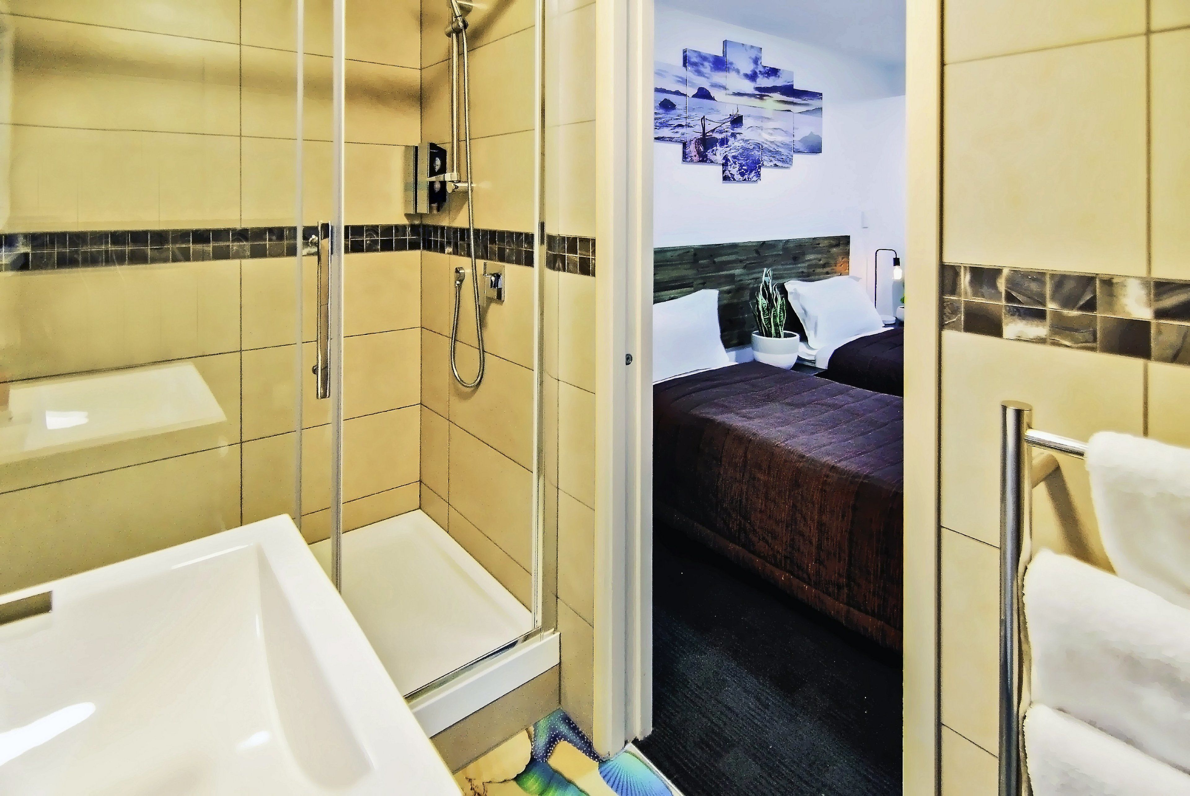 A bathroom with a shower, a bathtub, and a toilet.