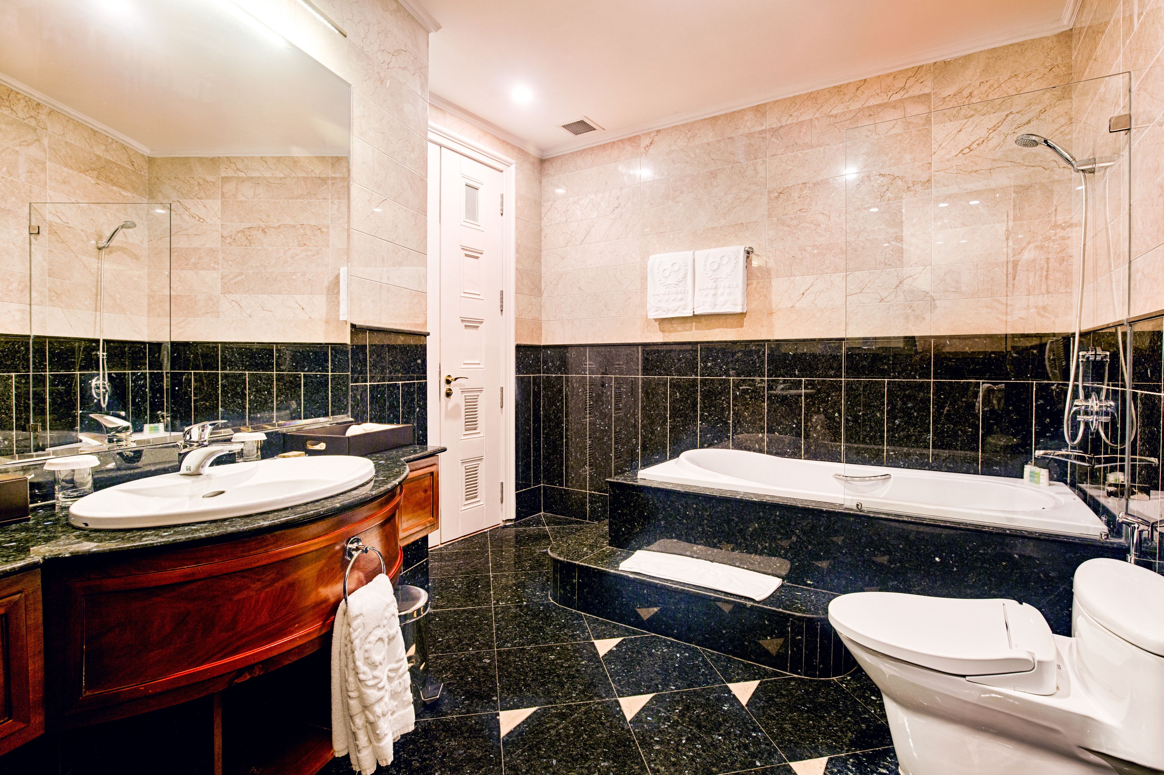 separate bathtub and shower, rainfall showerhead, designer toiletries