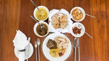 A table set with various dishes, utensils, and a napkin.