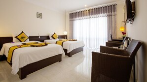 A hotel room with two beds, a TV, a chair, and a window with curtains. - Phuc Thao Villa (Da Nang)