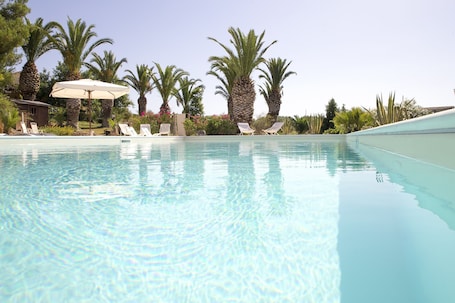 Seasonal outdoor pool, open 10:00 AM to 7:00 PM, pool umbrellas