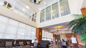 A spacious lobby with a high ceiling, large windows, and a seating area with sofas and a coffee table. - Hualien Lohas Hotel (Hualien City)