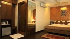 A compact hotel room with a bed, a small desk, and a wardrobe. - Hotel O2 VIP (Barasat)