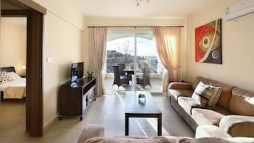 Apartment, 1 Bedroom, Sea View | Living area | Flat-screen TV