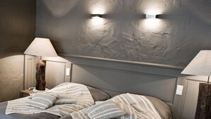 A modern bedroom with a large bed, two bedside tables, and a headboard with integrated lighting. - De Laurier (Knokke-Heist)