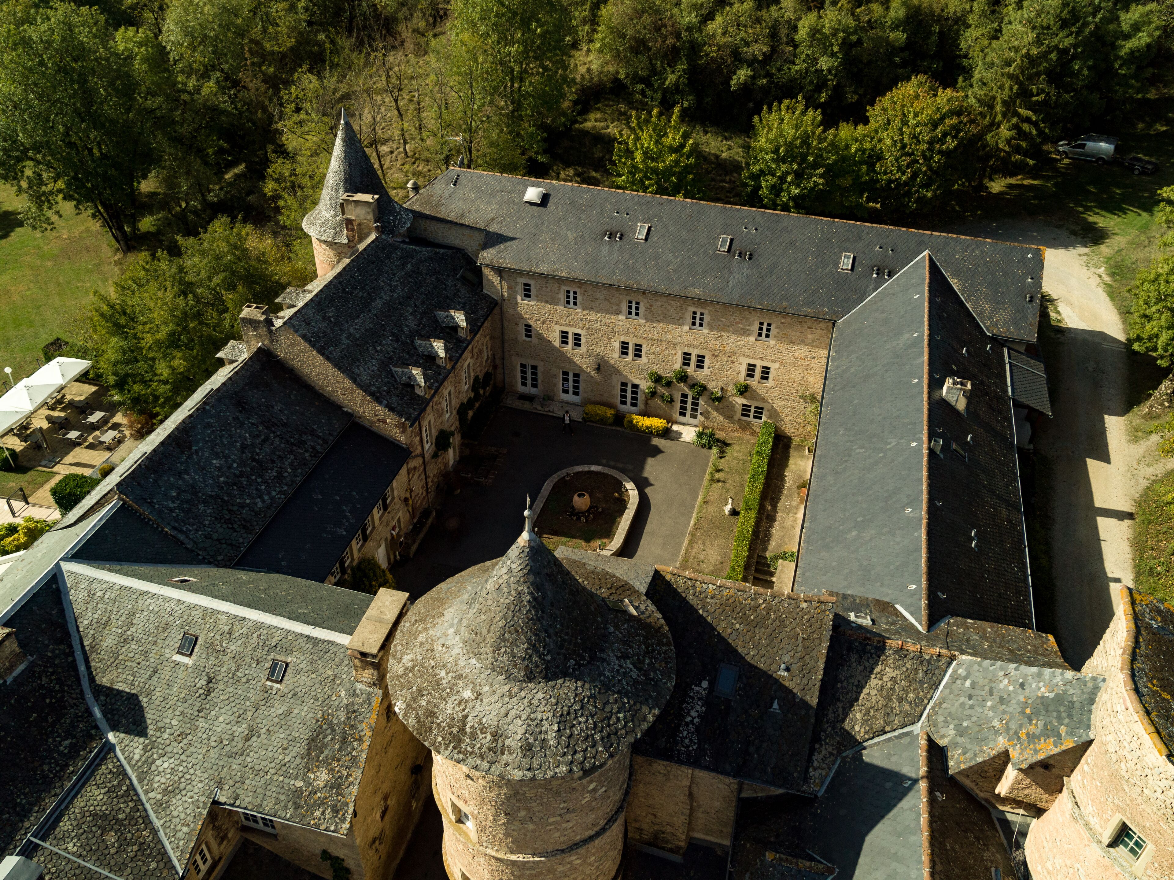 An aerial view of a historic building with multiple towers and a courtyard.
