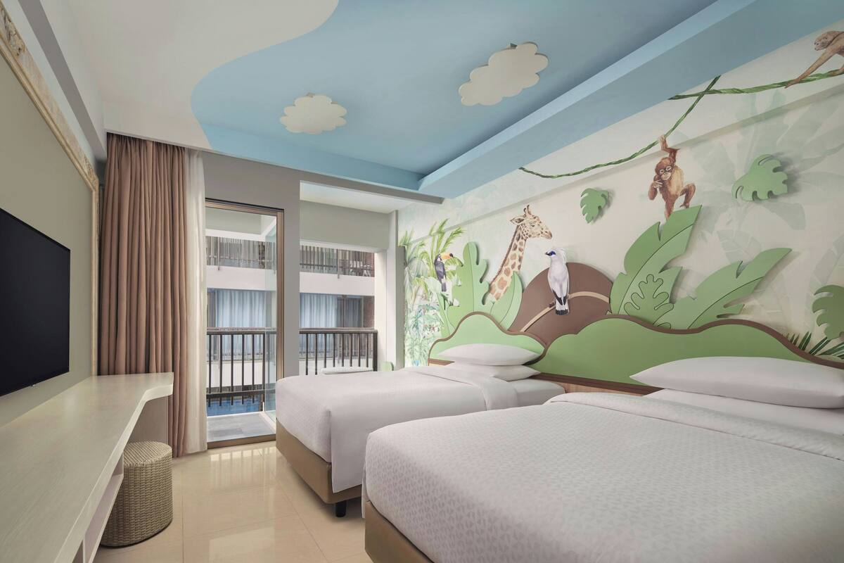 A hotel room with two beds, a TV, and a balcony with a view.