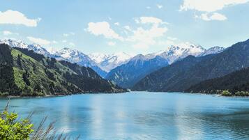 A lake surrounded by mountains with snow-capped peaks.