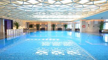 Indoor pool, open 8:00 AM to 11:00 PM, pool loungers