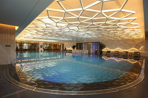 Indoor pool, open 8:00 AM to 11:00 PM, pool loungers