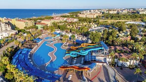 A resort with a large swimming pool, water slides, and a view of the sea. - VONRESORT Golden Coast - All Inclusive (Manavgat)