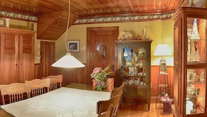 Une pièce au décor traditionnel, avec des meubles en bois, une table à manger et un lustre.