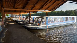 A covered boat dock with a view of a lake and forest. - Laguna Lodge (Colorado)