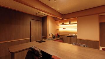 A modern kitchen with a wooden countertop, a sink, and a built-in oven.