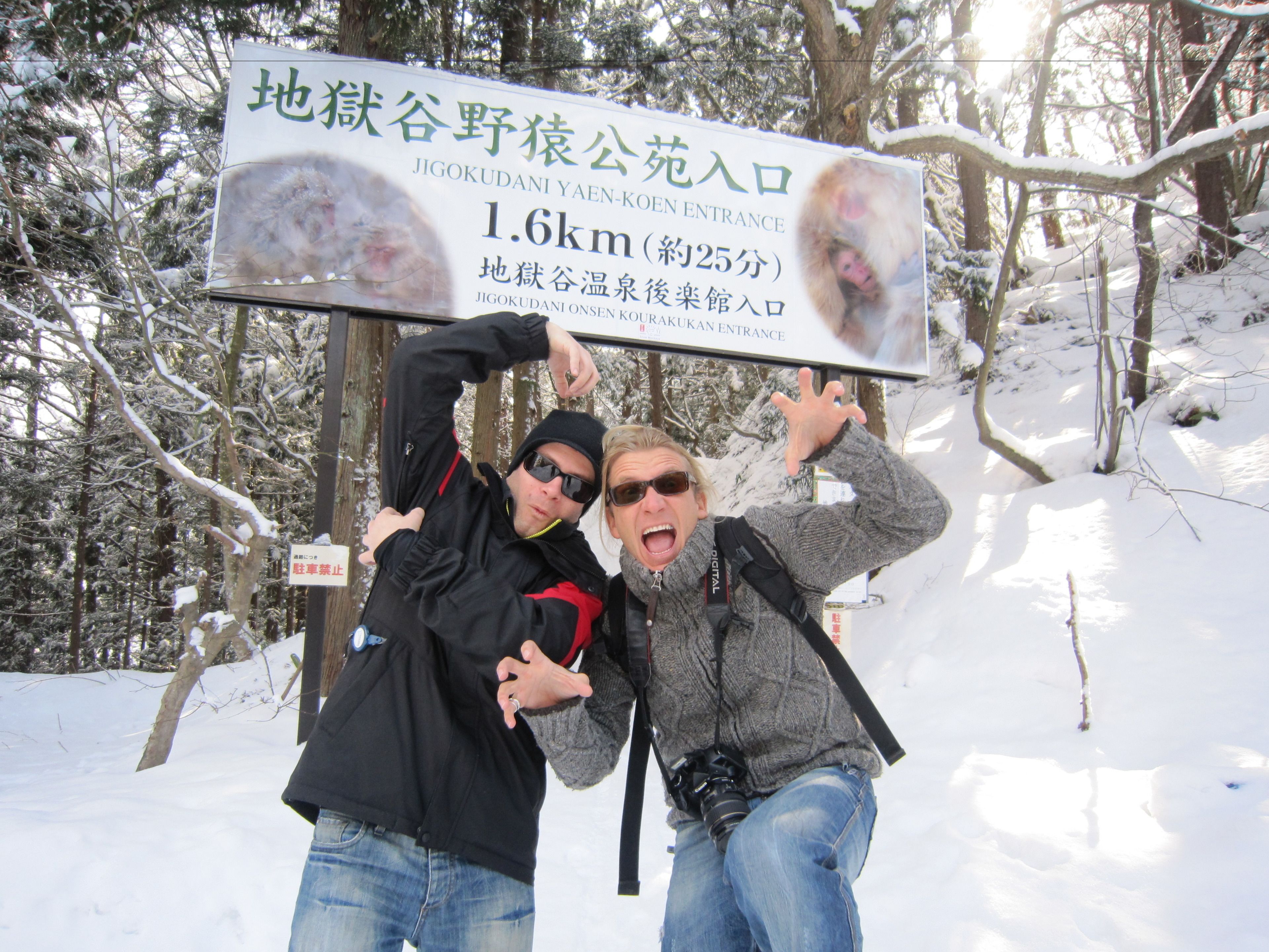 A sign with Japanese text indicating a distance of 1.6 km and a temperature of about 25 degrees.