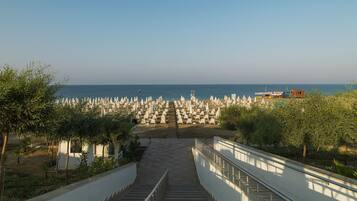 Private beach, black sand, sun-loungers, beach umbrellas