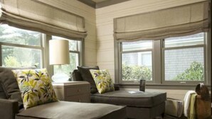 A modern living room with a sofa, ottoman, and a zebra-patterned rug. - Morgan and Wells B&B (Shelby)