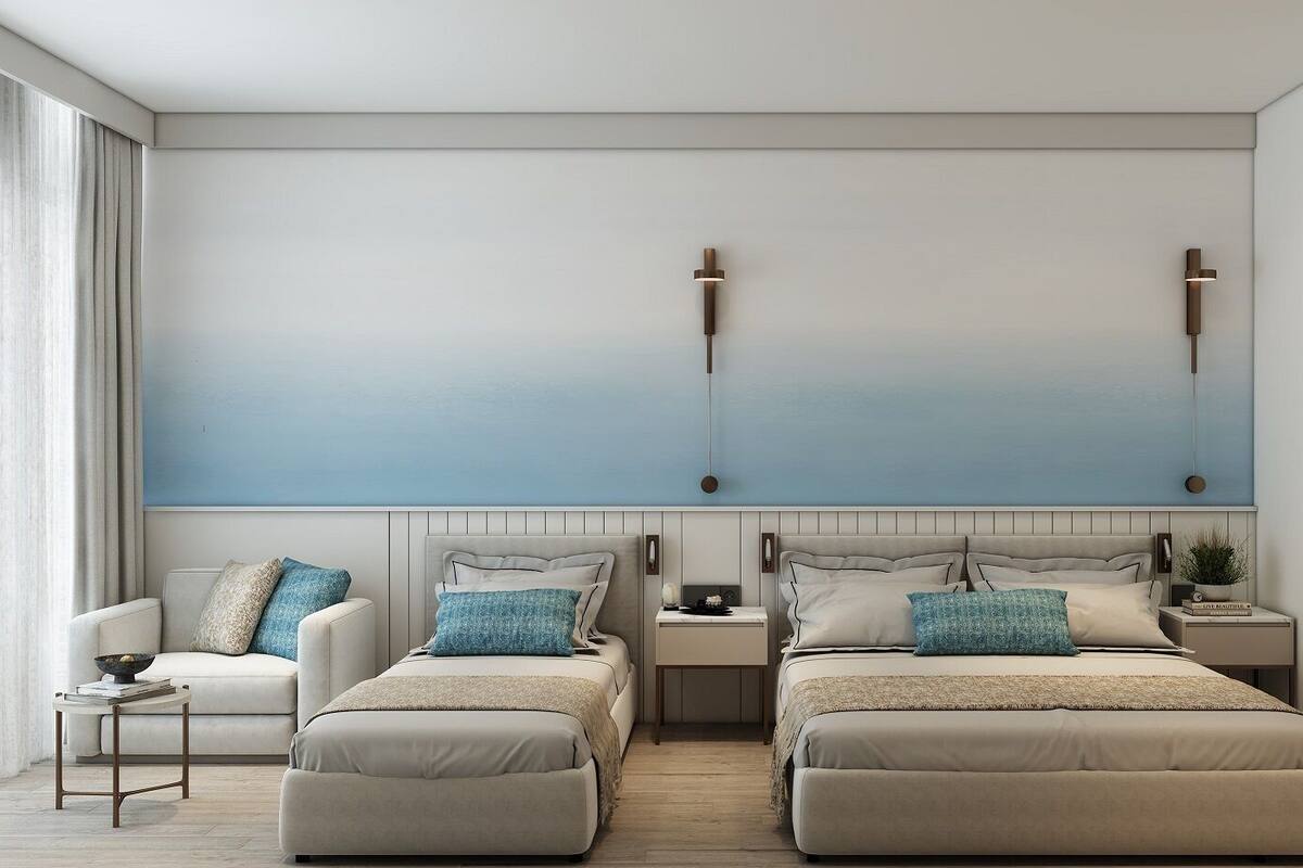 A modern bedroom with two beds, a nightstand, a lamp, and a large window with curtains.