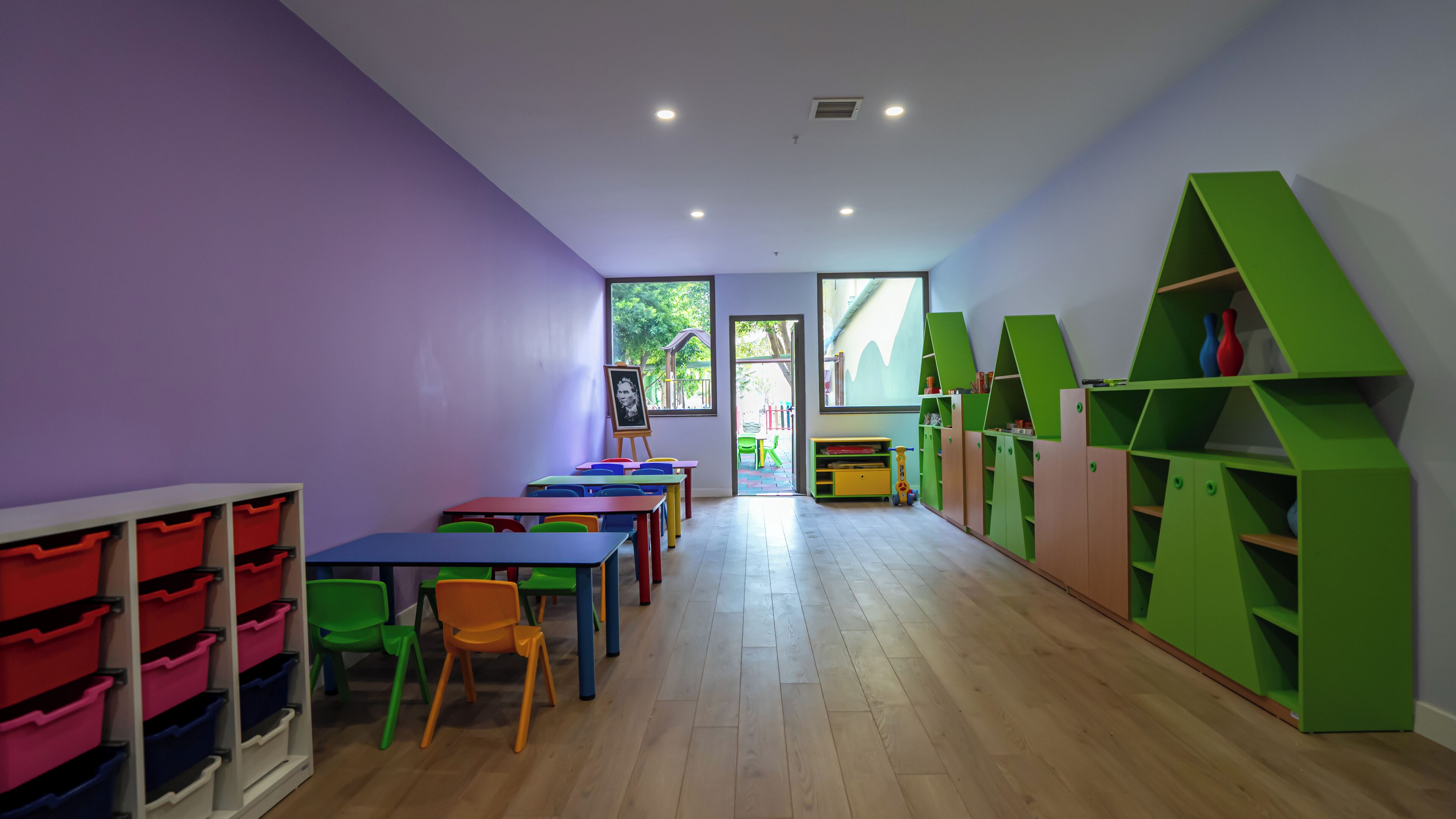 A classroom with colorful furniture and storage units.