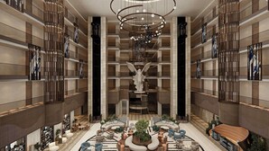 A spacious atrium with a central seating area, multiple floors with balconies, and a modern chandelier. - Calido Sol Hotel - All inclusive (Alanya)