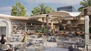 An outdoor café with wicker furniture, a bar area, and shelves with pottery. - Calido Sol Hotel - All inclusive (Alanya)