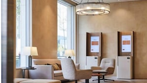 A modern lobby with seating, a large chandelier, and information kiosks. - LOTTE CITY HOTEL ULSAN (Ulsan)