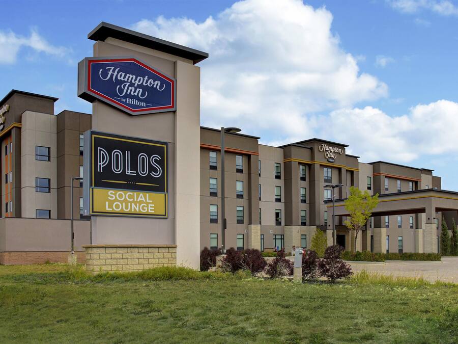 A Hampton Inn hotel with a visible sign for the social lounge.