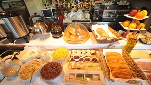A buffet with various food items and condiments. - Dream Hotel (Tirana)
