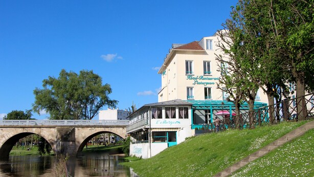 A riverside hotel with a bridge, a restaurant, and a view of the water. - Hotel Restaurant L'Esturgeon (Poissy)