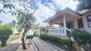 A two-story house with a covered porch and a staircase leading to the upper floor. - Krisada Beach Resort (Koh Samui)