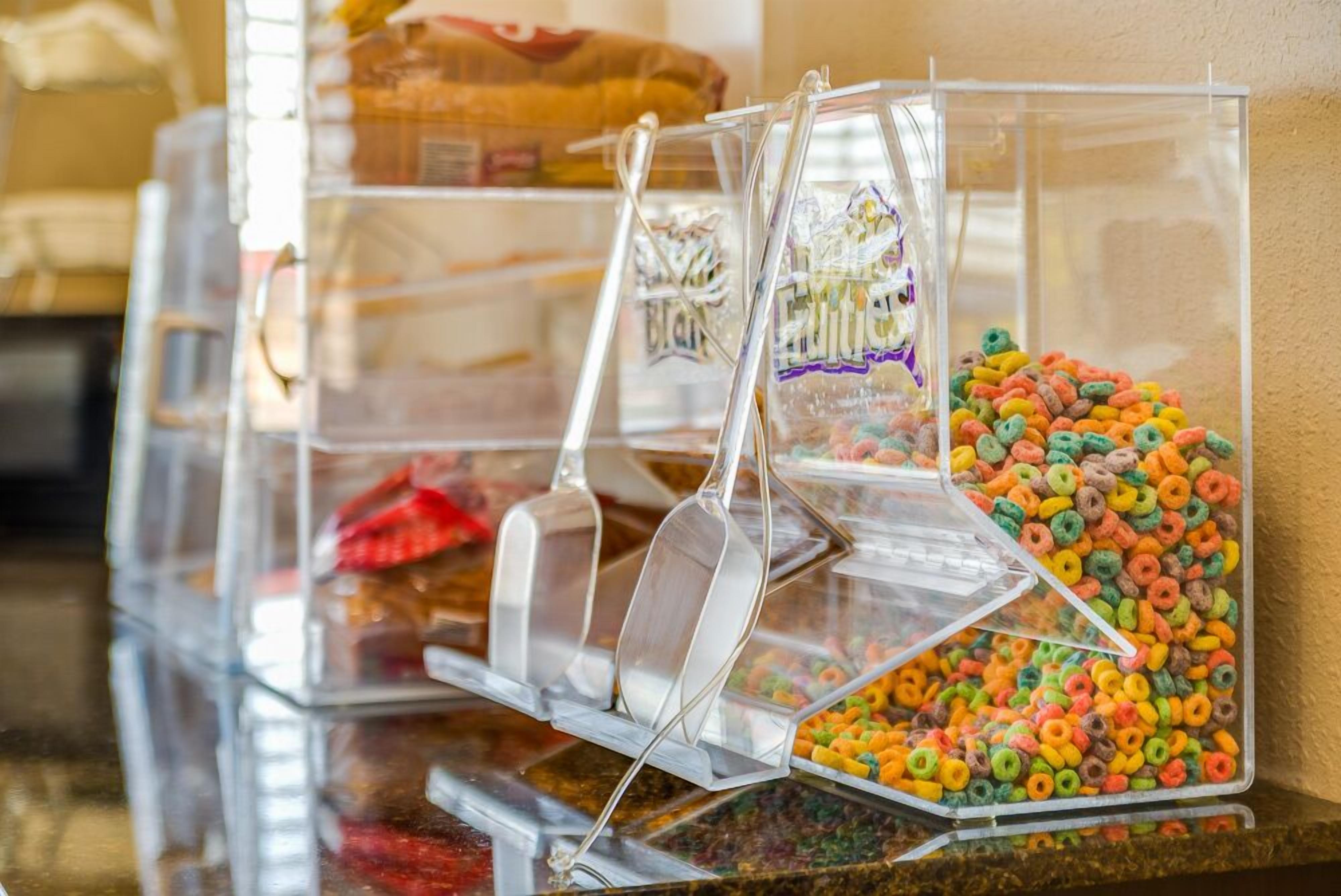 A cereal dispenser with multiple compartments, each containing different types of cereal.