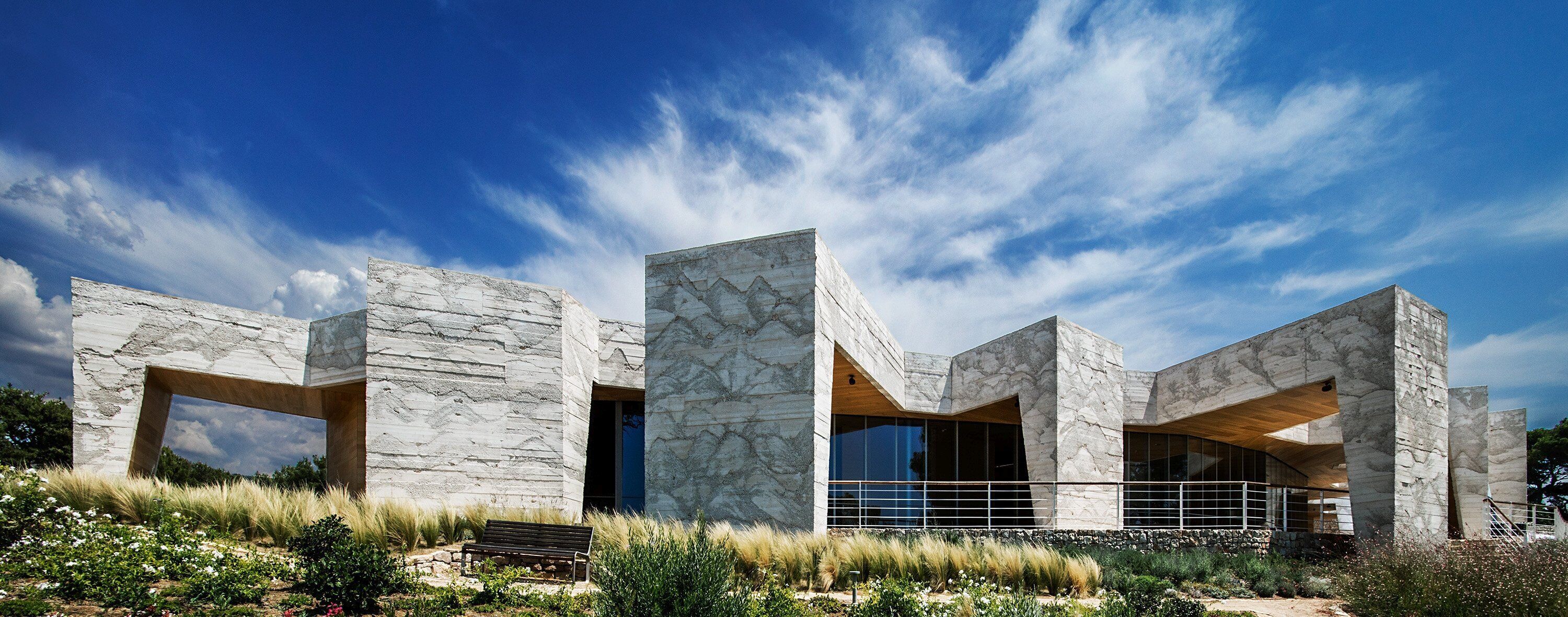 A modern building with a stone facade and large windows.