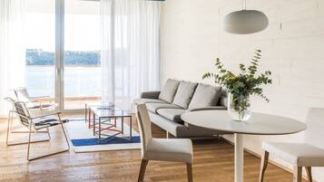 A modern living room with a sofa, a round table, and a chair.